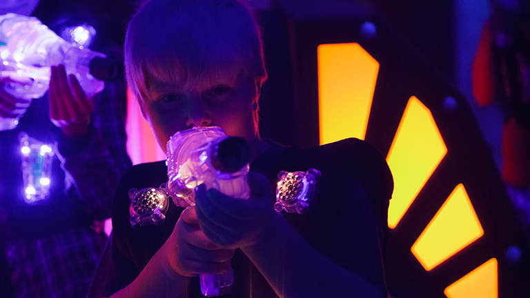 little boy playing laser tag