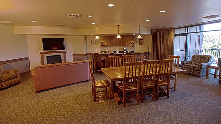 Royal Hospitality suite dining room with a living room and kitchen in the background