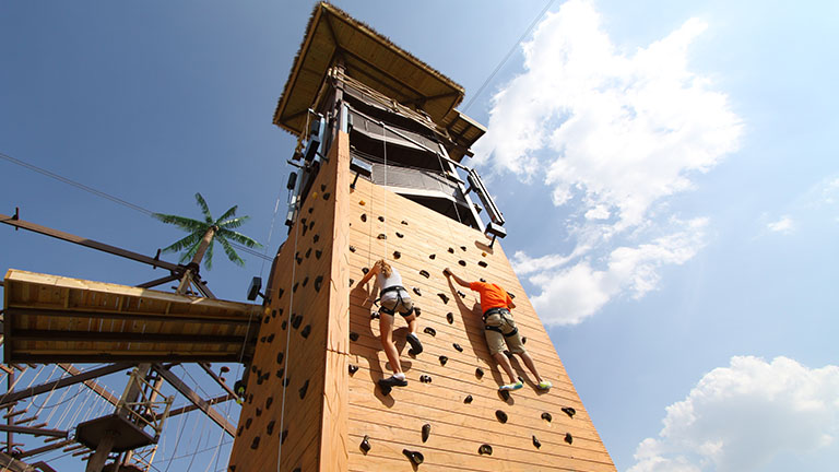 couple kids climbing the rock wall at safari outdoor adventure park
