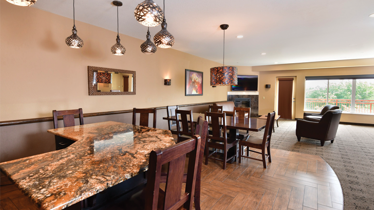 an overview of inside the Royal Hospitality Suite. Consists of kitchen area and fancy dining area.