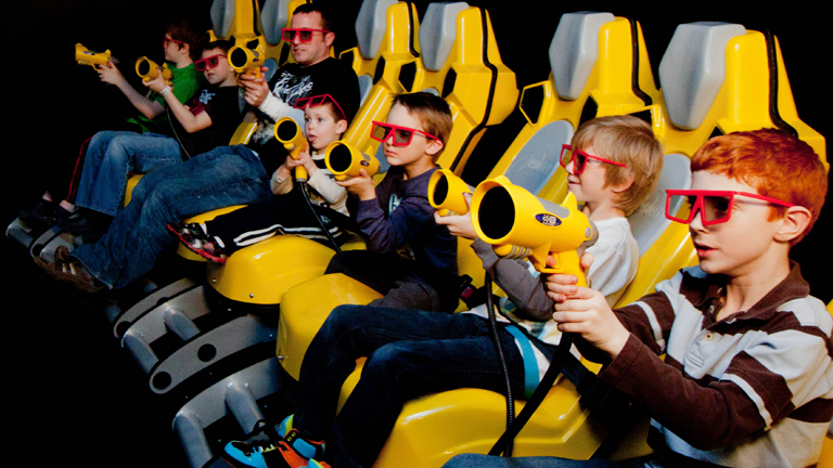 a group of kids playing in the 7-D motion theatre